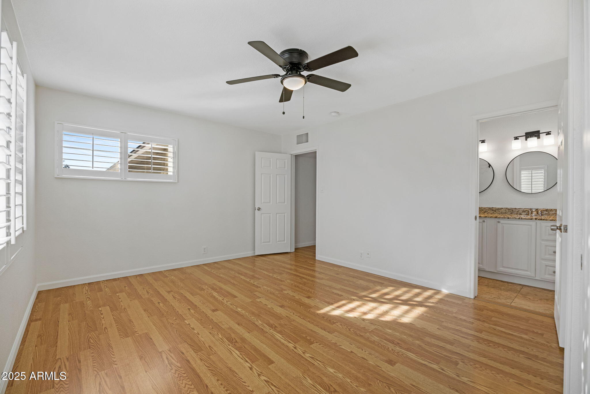 4020 North 44th Place Phoenix, AZ 85018 - Photo 10 of 17 a view of empty room with wooden floor