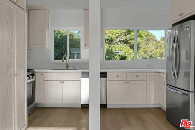 a bathroom with a sink a mirror and a window