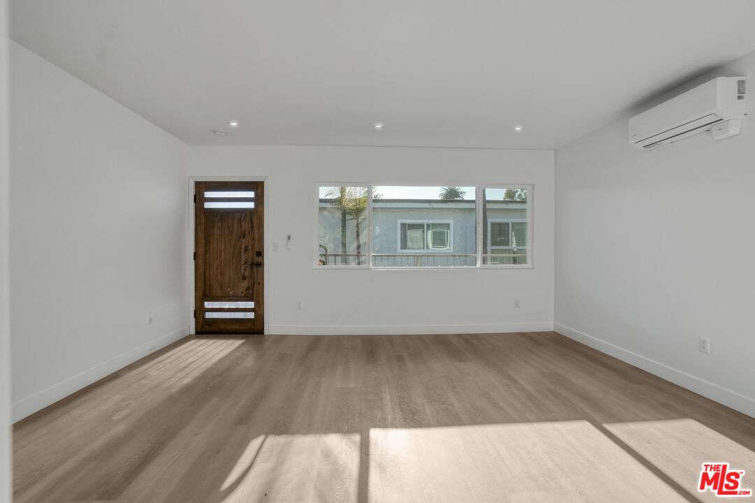 559 Sunset Avenue Venice, CA 90291 - Photo 6 of 16 wooden floor in an empty room with a window