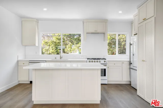 a kitchen with a stove a sink and a refrigerator