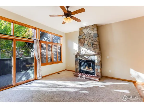 a living room with a fireplace and a floor to ceiling window