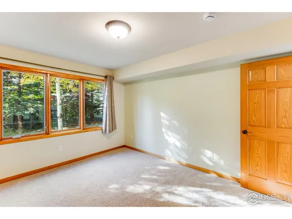 an empty room with windows and view of house