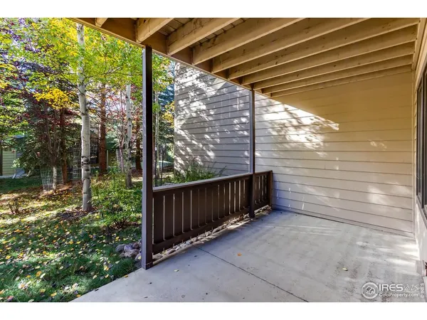 a view of a porch with a floor to ceiling window and wooden fence