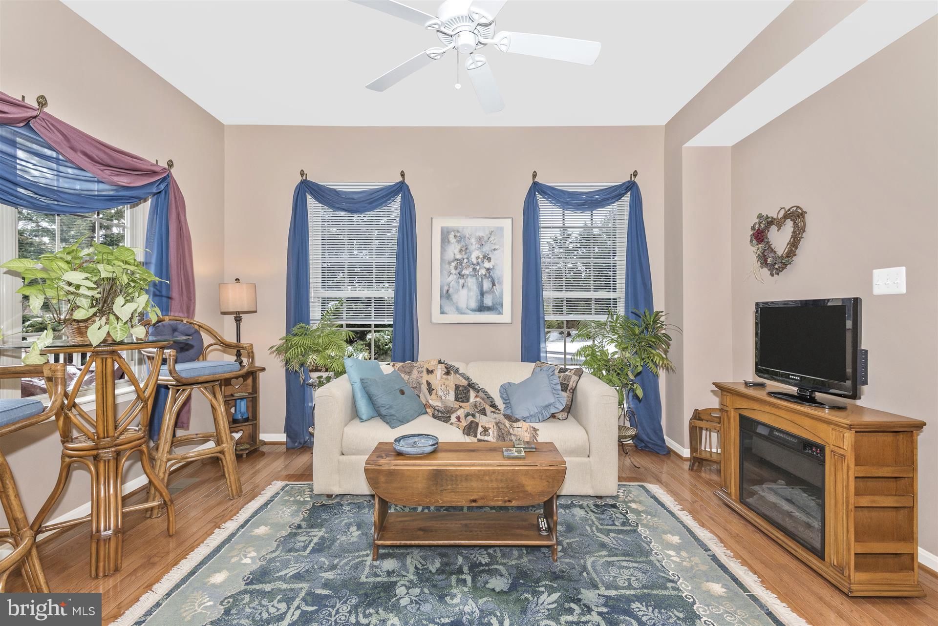 2400 Rippling Brook Road Frederick, MD 21701 - Photo 6 of 30 Sunny family room with hardwood flooring