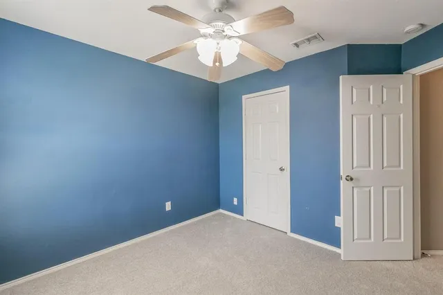 a view of a livingroom with a chandelier fan