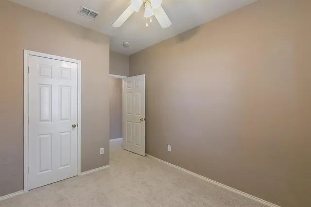 an empty room with closet area