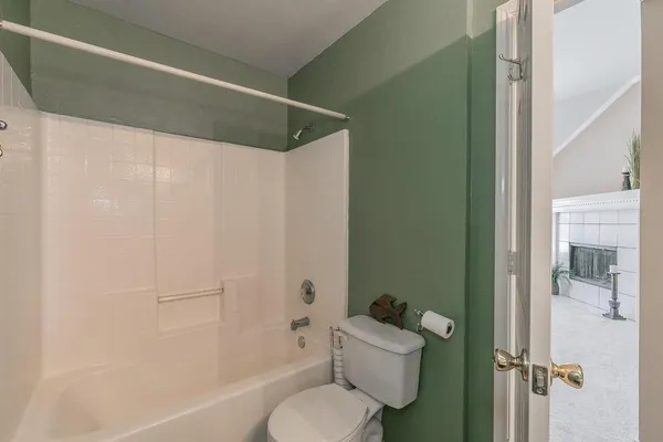 a bathroom with a toilet and a shower