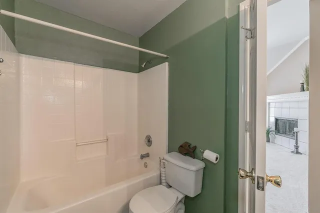 a bathroom with a toilet and a shower