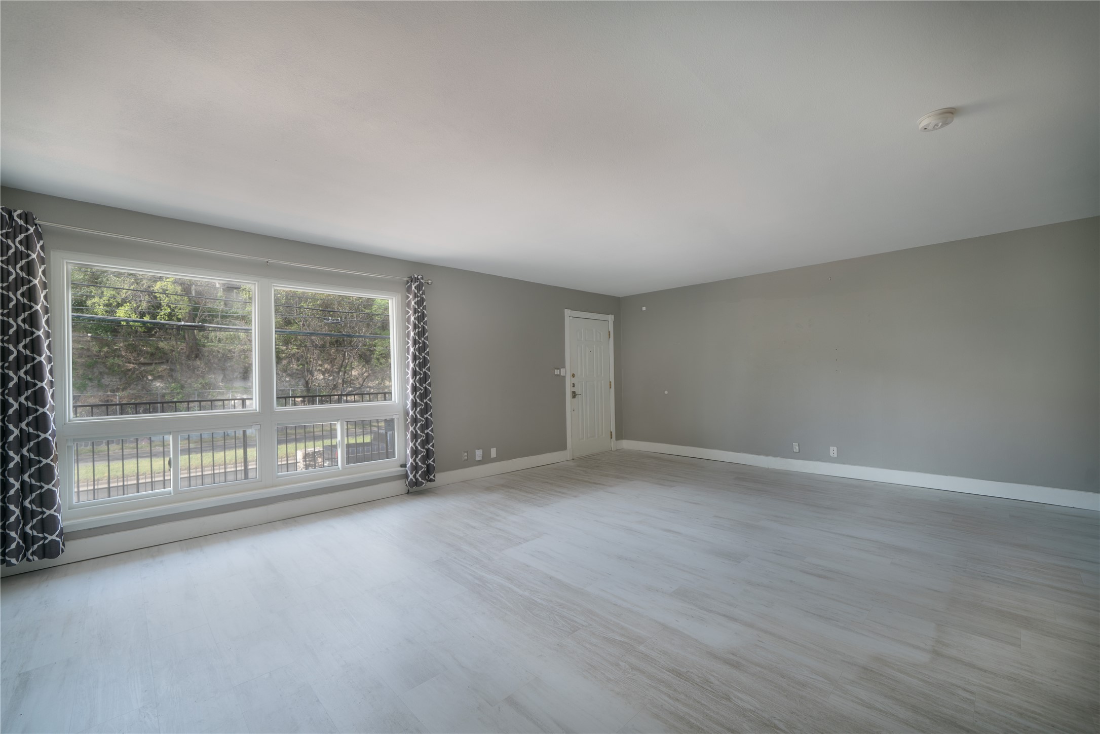 500 East Riverside Drive, Unit 242 Austin, TX 78704 - Photo 4 of 40 Spare room featuring baseboards and wood finished floors