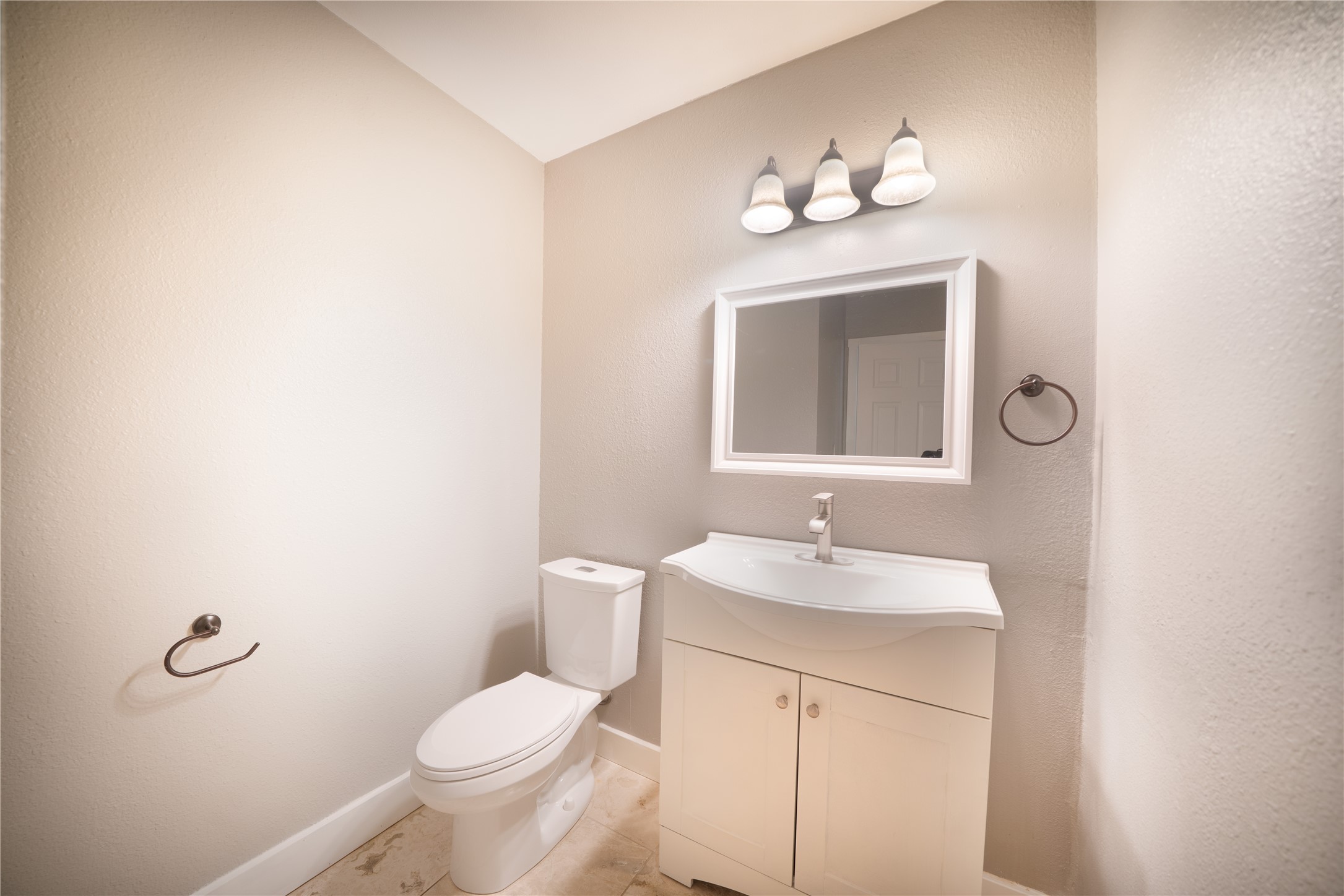 500 East Riverside Drive, Unit 242 Austin, TX 78704 - Photo 7 of 40 Half bathroom featuring tile patterned floors, baseboards, toilet, and vanity