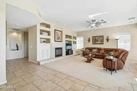 a kitchen with stainless steel appliances granite countertop a potted plant on the granite counter tops and a view of living room