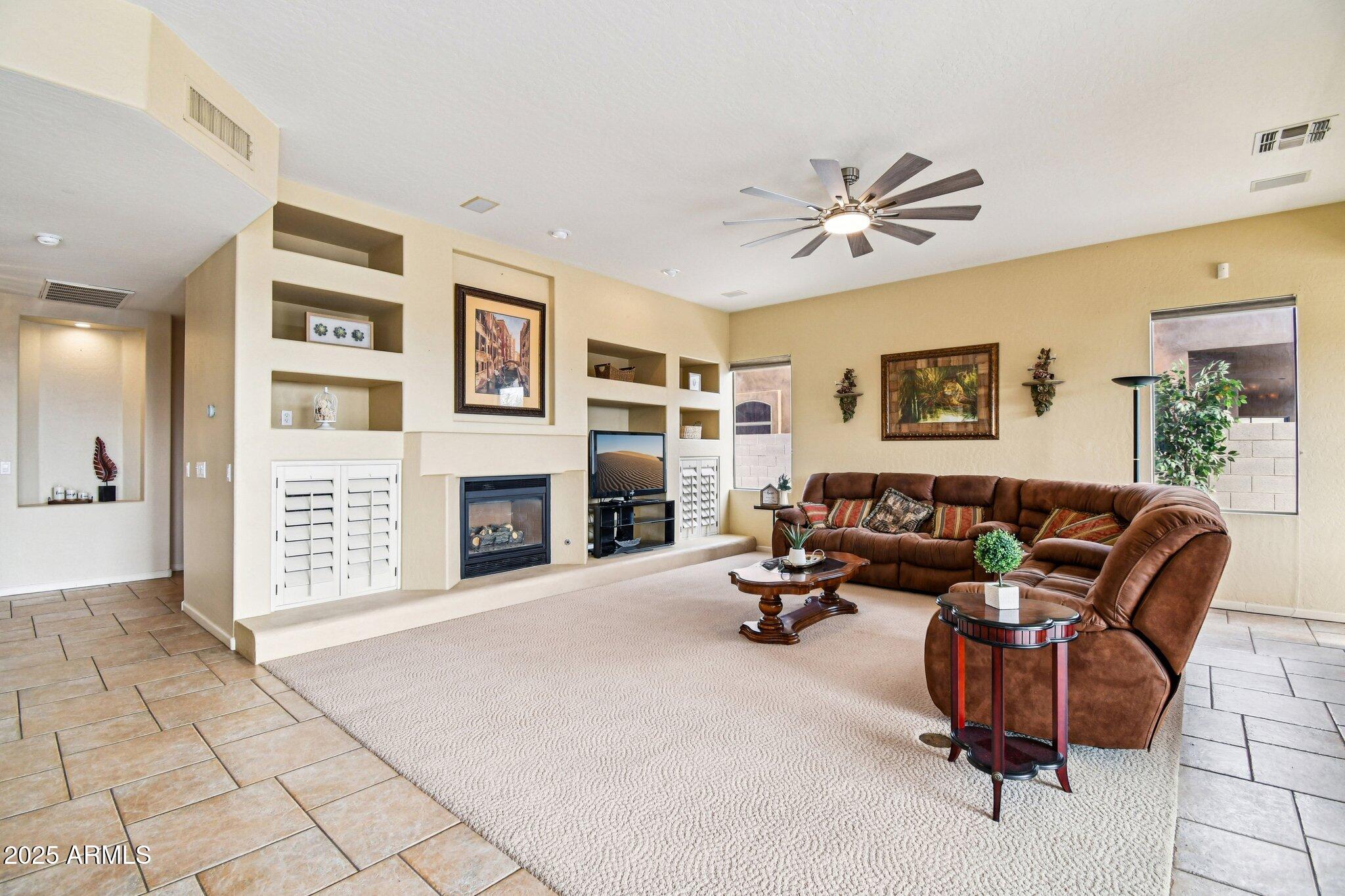 923 West Windsong Drive Phoenix, AZ 85045 - Photo 17 of 57 a living room with furniture and a fireplace