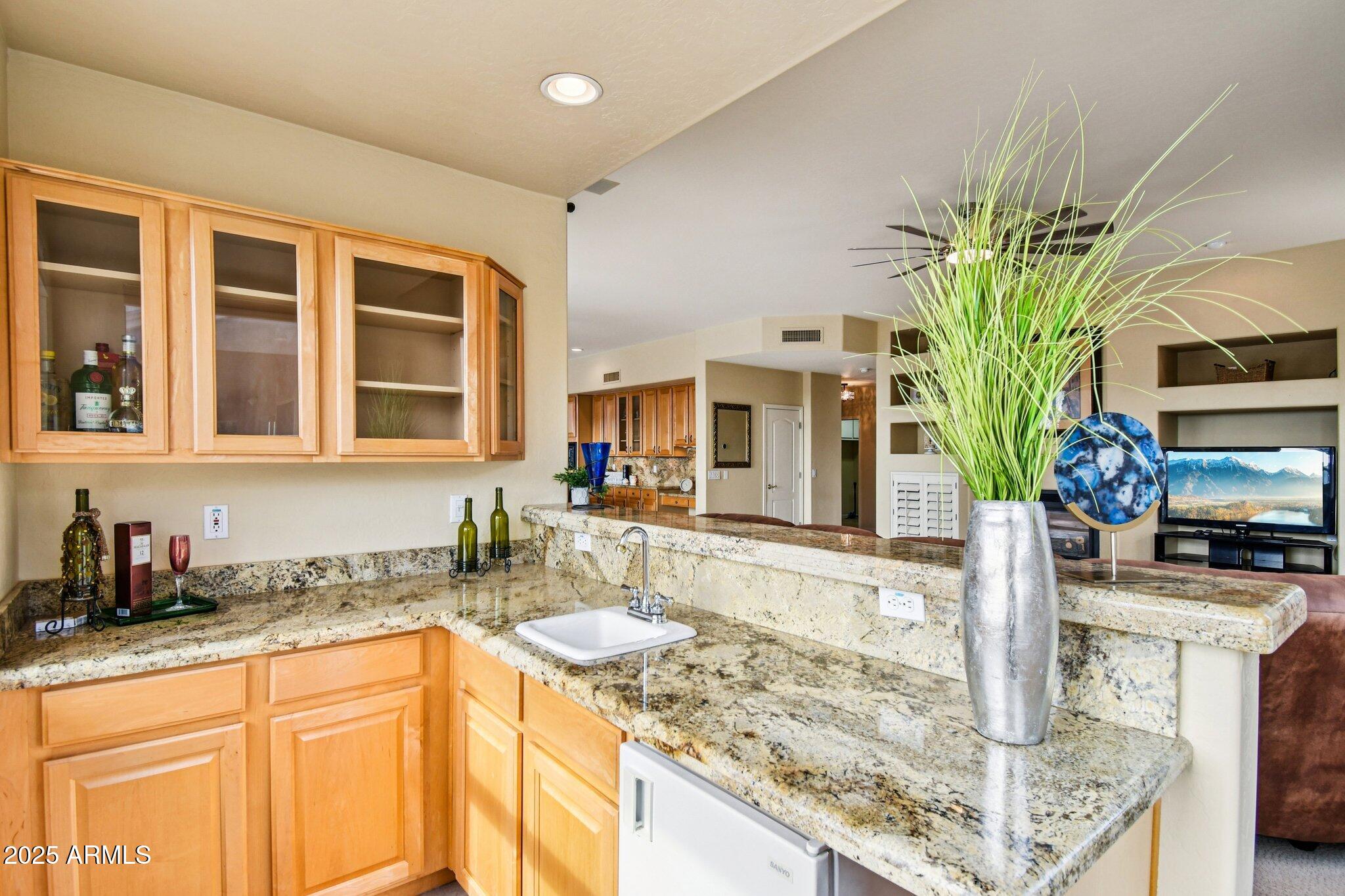 923 West Windsong Drive Phoenix, AZ 85045 - Photo 18 of 57 a kitchen with stainless steel appliances granite countertop a sink a stove and a wooden cabinets