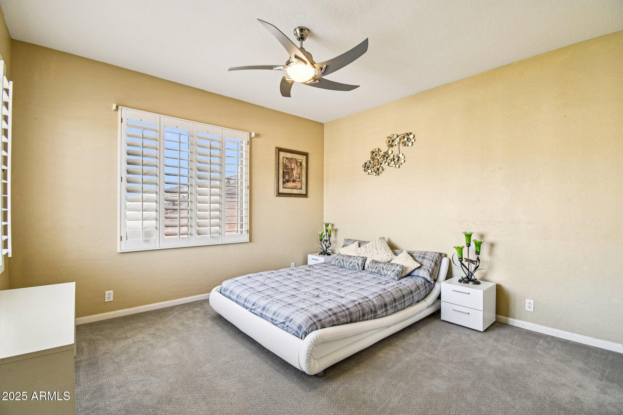 923 West Windsong Drive Phoenix, AZ 85045 - Photo 27 of 57 a bedroom with a bed and ceiling fan