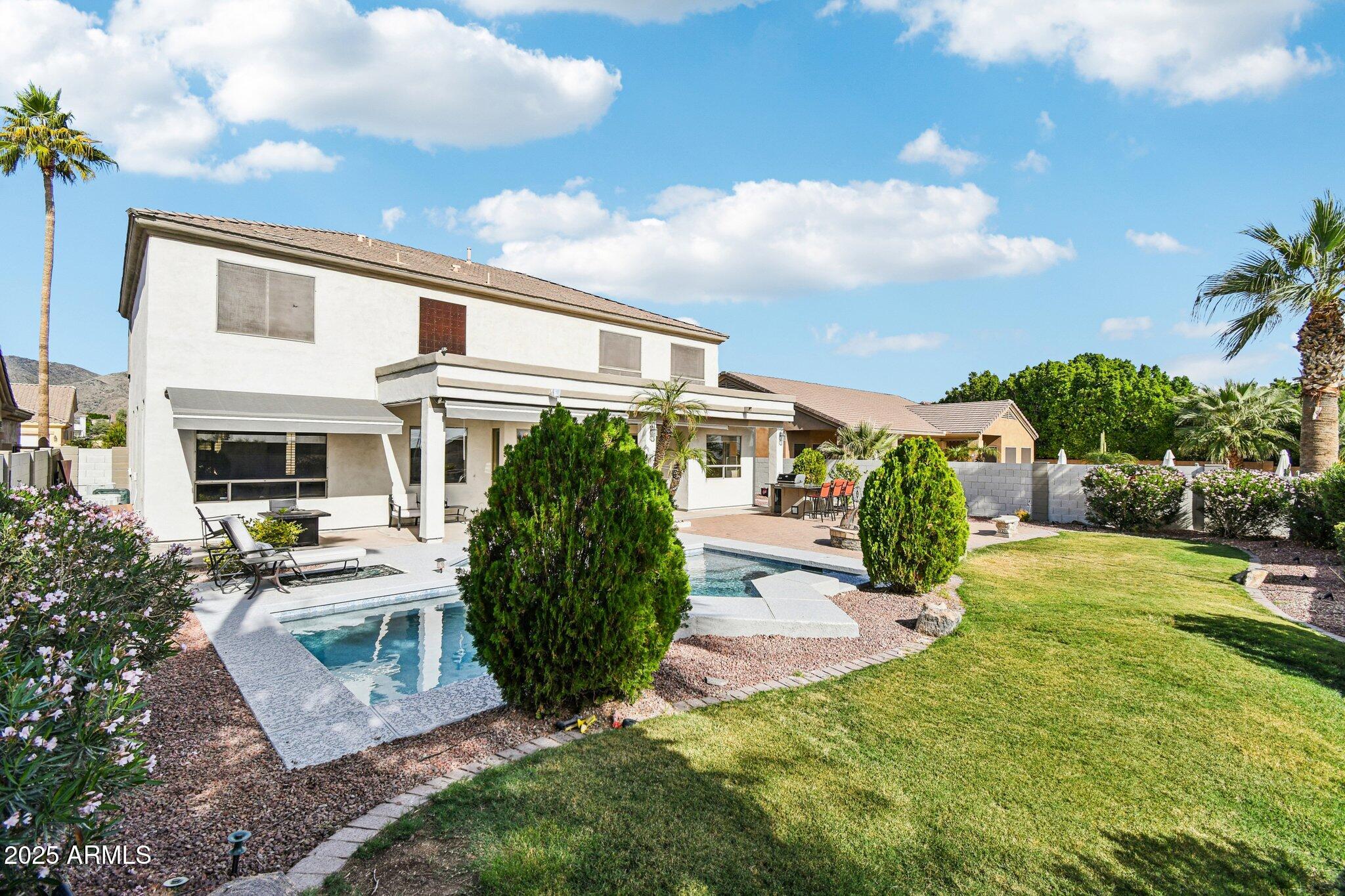 923 West Windsong Drive Phoenix, AZ 85045 - Photo 34 of 57 a front view of a house with a yard table and chairs