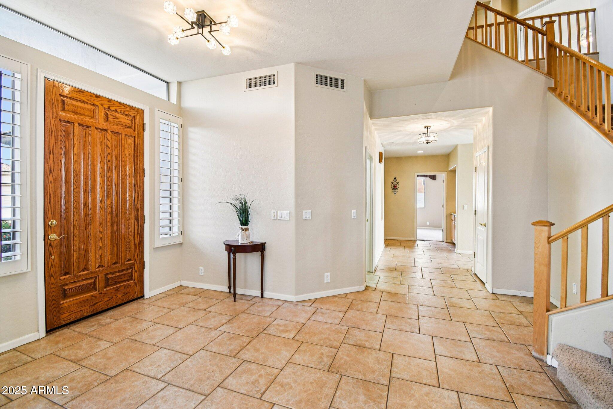 923 West Windsong Drive Phoenix, AZ 85045 - Photo 7 of 57 a view of a hallway view with wooden floor and staircase