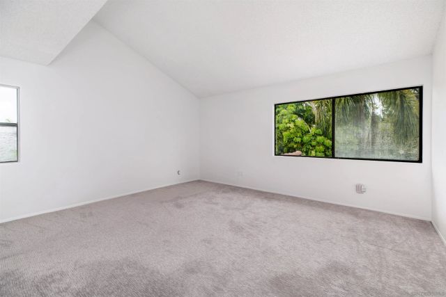 an empty room with large windows