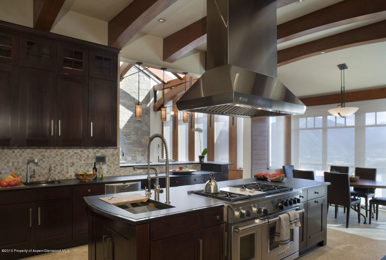 570 Eppley Drive Aspen, CO 81612 - Photo 9 of 23 a kitchen with stainless steel appliances granite countertop a stove a sink dishwasher and cabinets with wooden floor
