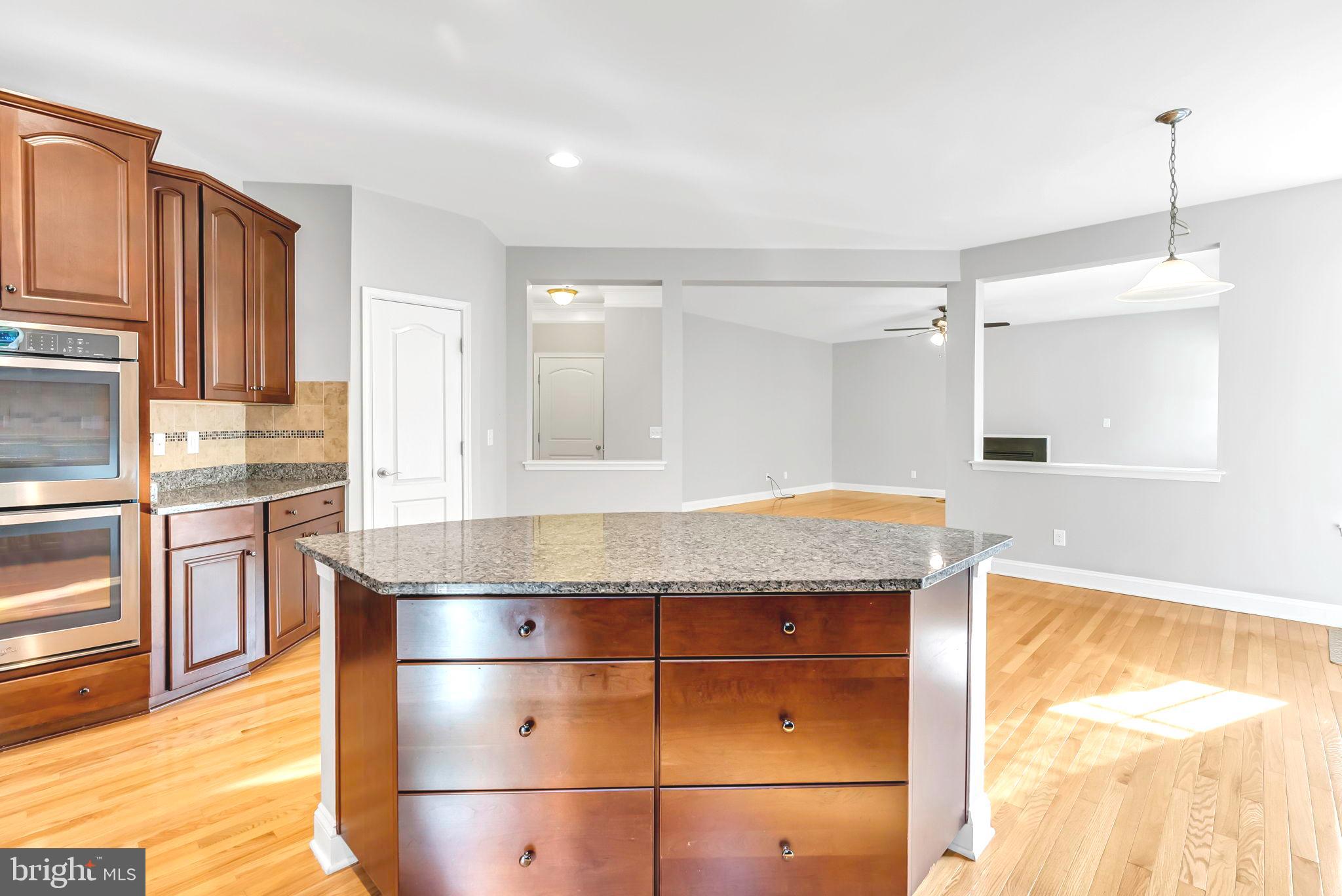 40560 Aldie Springs Drive Aldie, VA 20105 - Photo 13 of 68 a kitchen with granite countertop a oven a counter space and cabinets