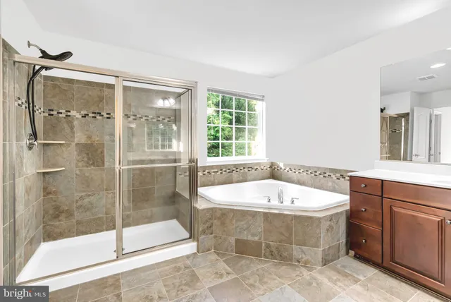 a bathroom with a sink a mirror and a bathtub