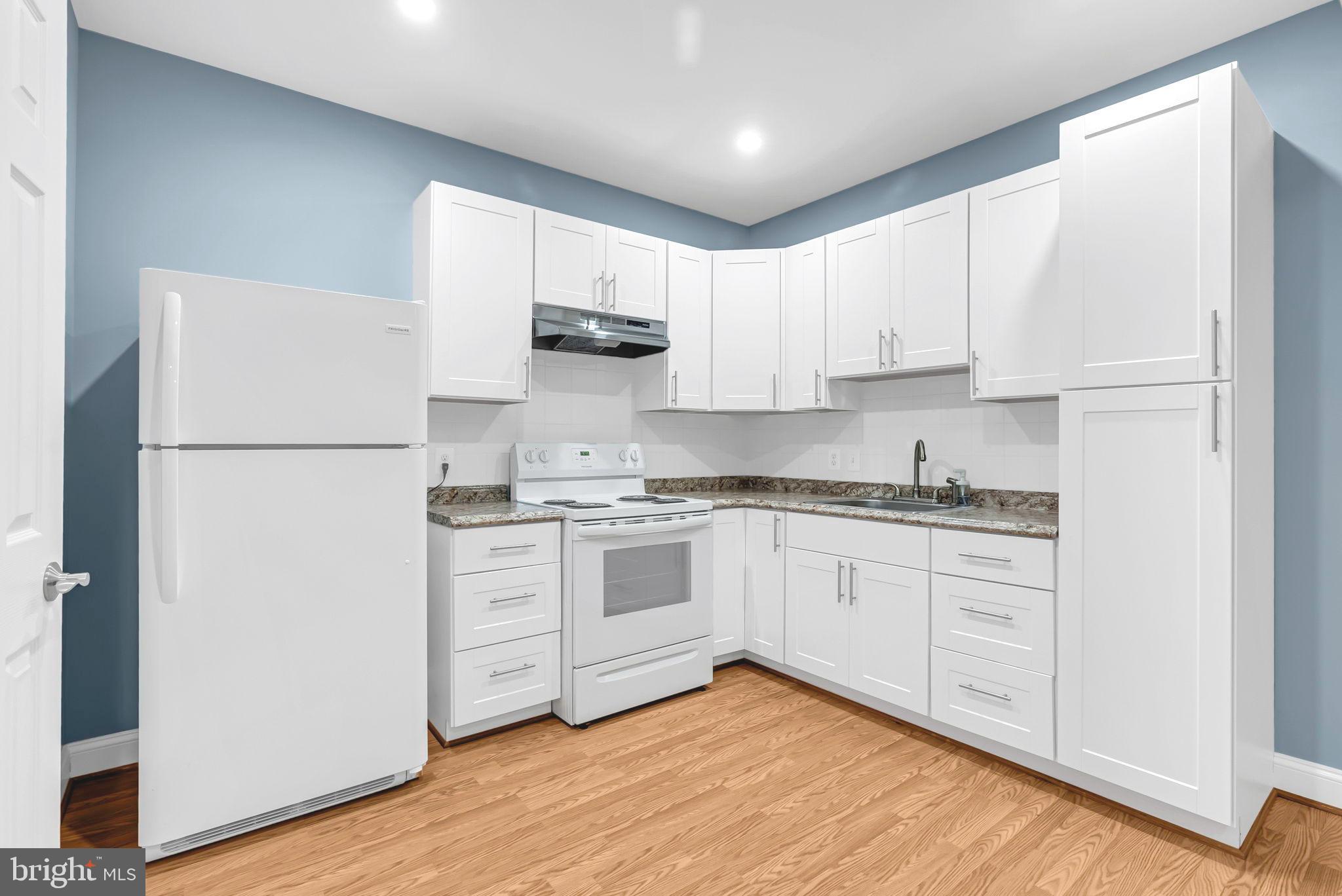 40560 Aldie Springs Drive Aldie, VA 20105 - Photo 60 of 68 a kitchen with white cabinets and white appliances