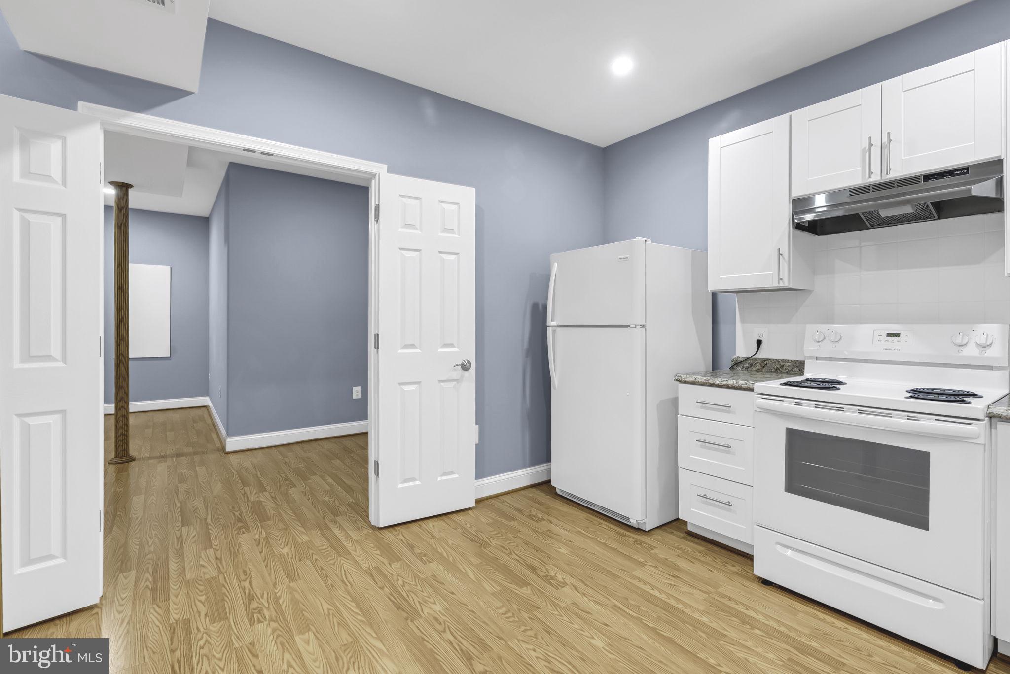 40560 Aldie Springs Drive Aldie, VA 20105 - Photo 63 of 68 a kitchen with a white cabinets and white appliances