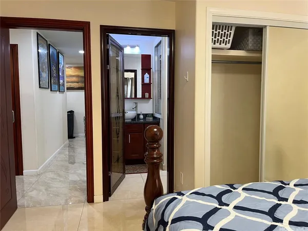 a bedroom with a bed and a mirror