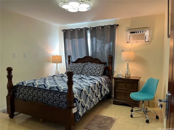 a bedroom with a bed and a chair