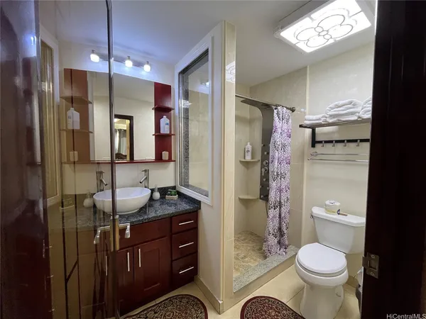a bathroom with a sink toilet and shower