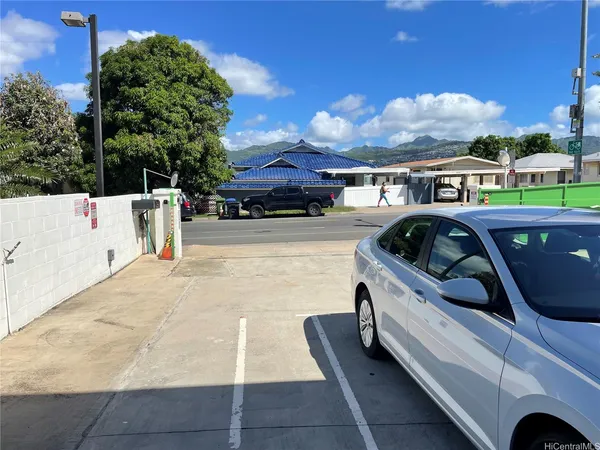 a view of a patio with table and chairs with an umbrella