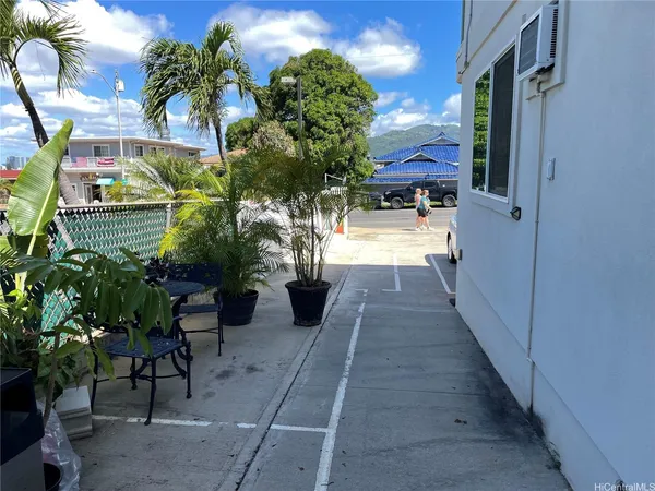 a view of a porch with chairs and potted plants
