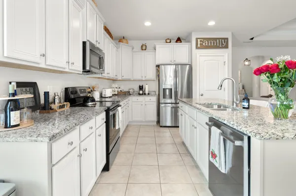 a kitchen with stainless steel appliances granite countertop a sink counter space cabinets and a granite counter tops
