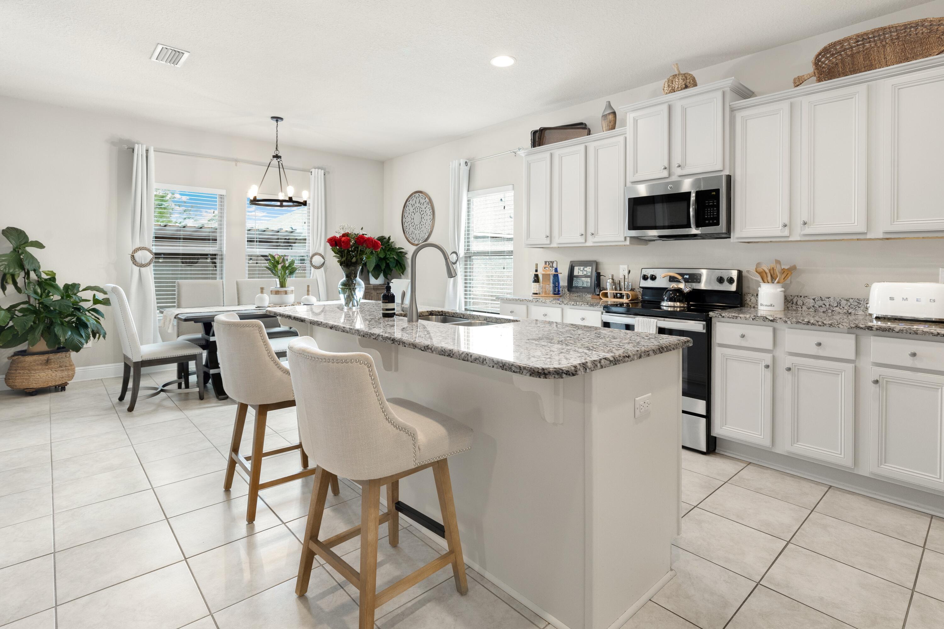 114 Maddox Street Santa Rosa Beach, FL 32459 - Photo 12 of 31 a kitchen with stainless steel appliances kitchen island granite countertop a sink and cabinets