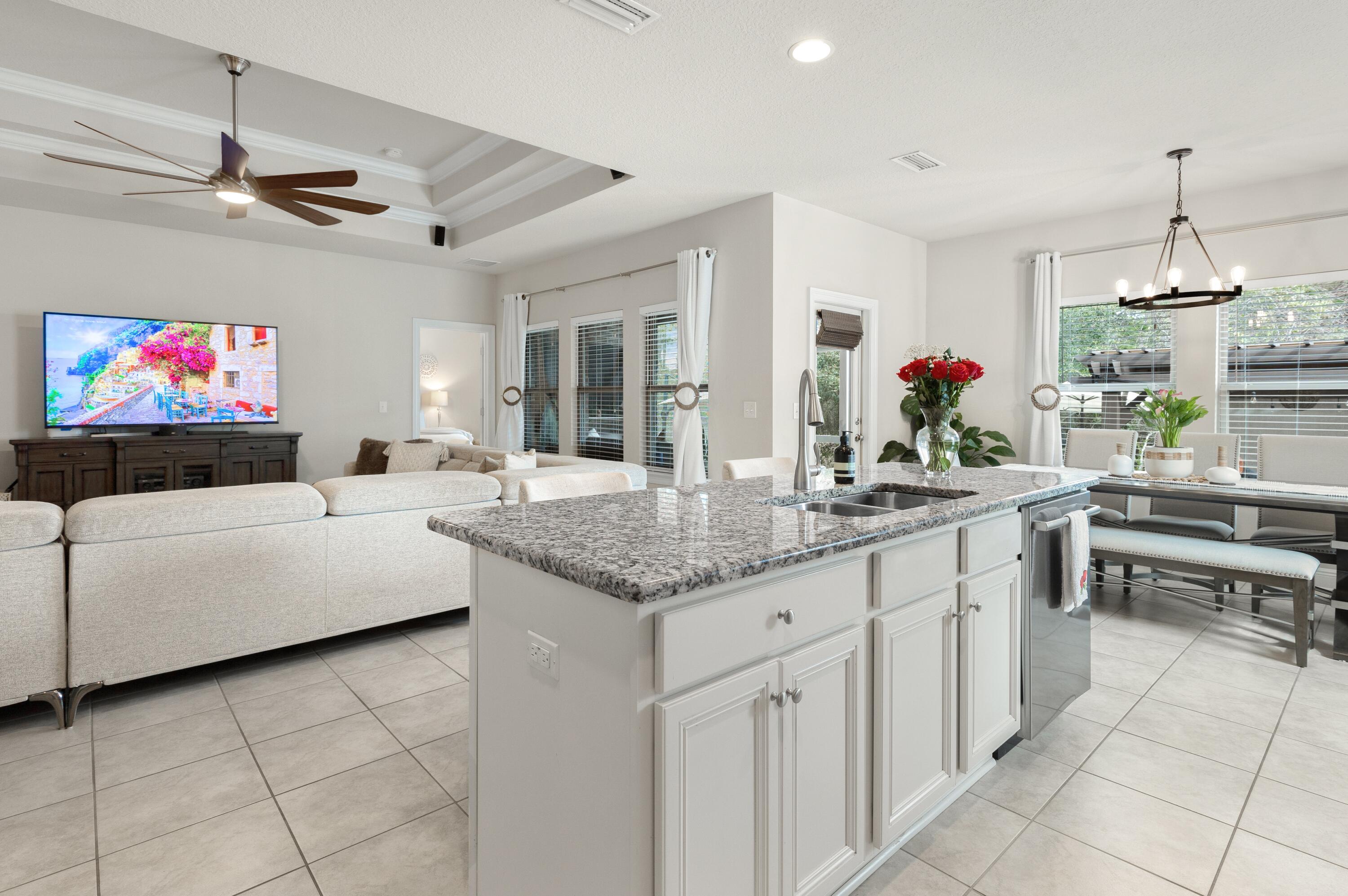 114 Maddox Street Santa Rosa Beach, FL 32459 - Photo 13 of 31 a kitchen with kitchen island granite countertop a sink cabinets and window