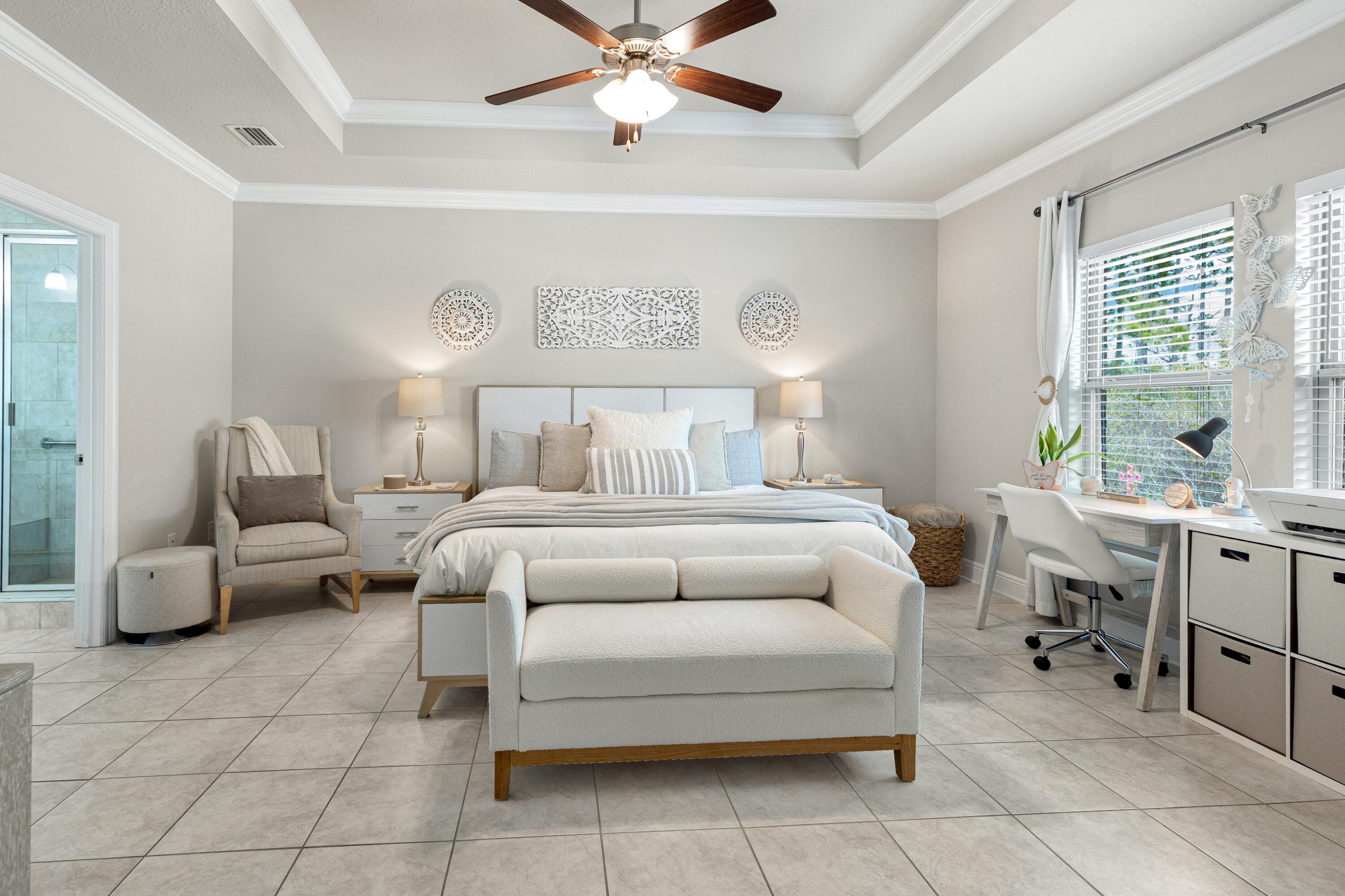 114 Maddox Street Santa Rosa Beach, FL 32459 - Photo 15 of 31 a bedroom with a bed and a chandelier