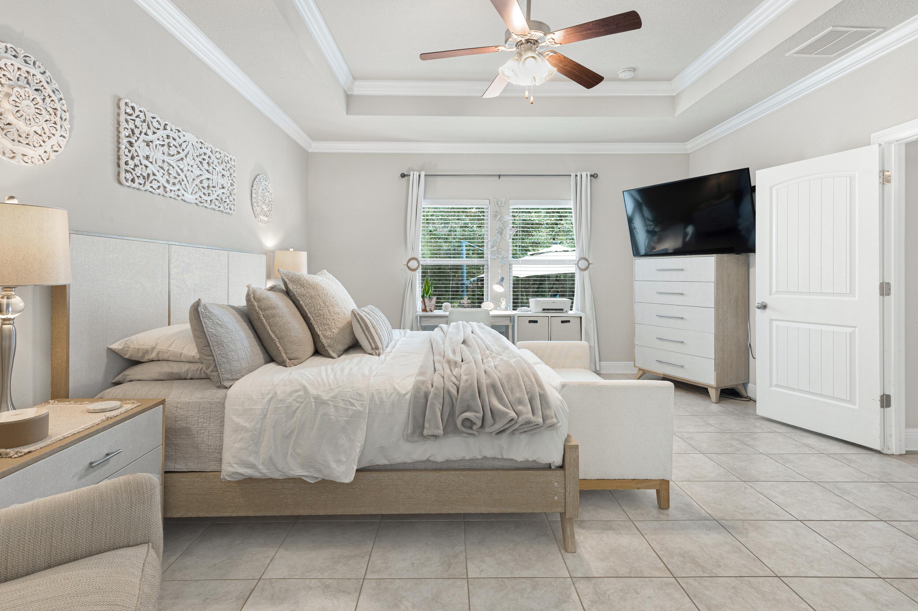 114 Maddox Street Santa Rosa Beach, FL 32459 - Photo 16 of 31 a spacious bedroom with a bed and a flat screen tv