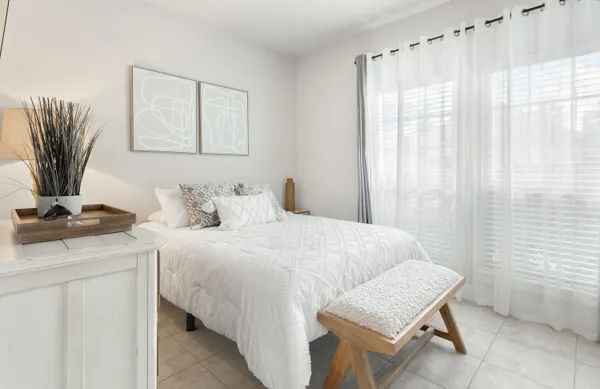 a bedroom with a bed and a table in it
