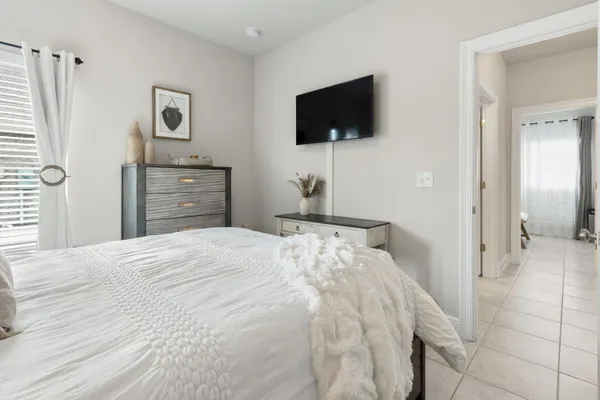 a bedroom with a bed and a flat screen tv