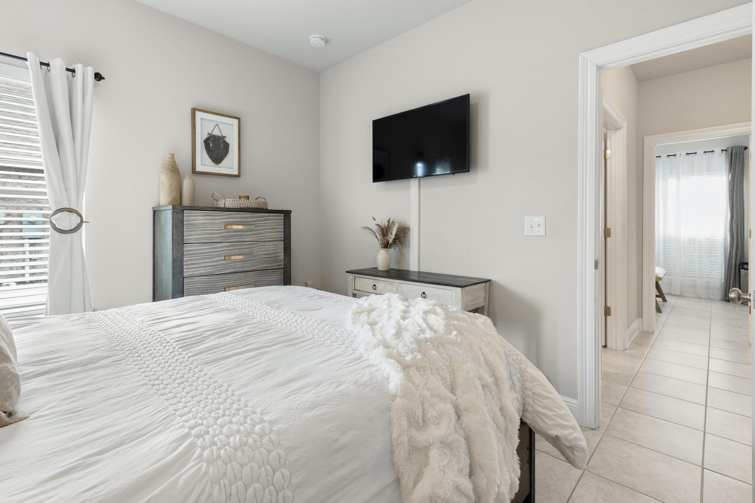 114 Maddox Street Santa Rosa Beach, FL 32459 - Photo 20 of 31 a bedroom with a bed and a flat screen tv