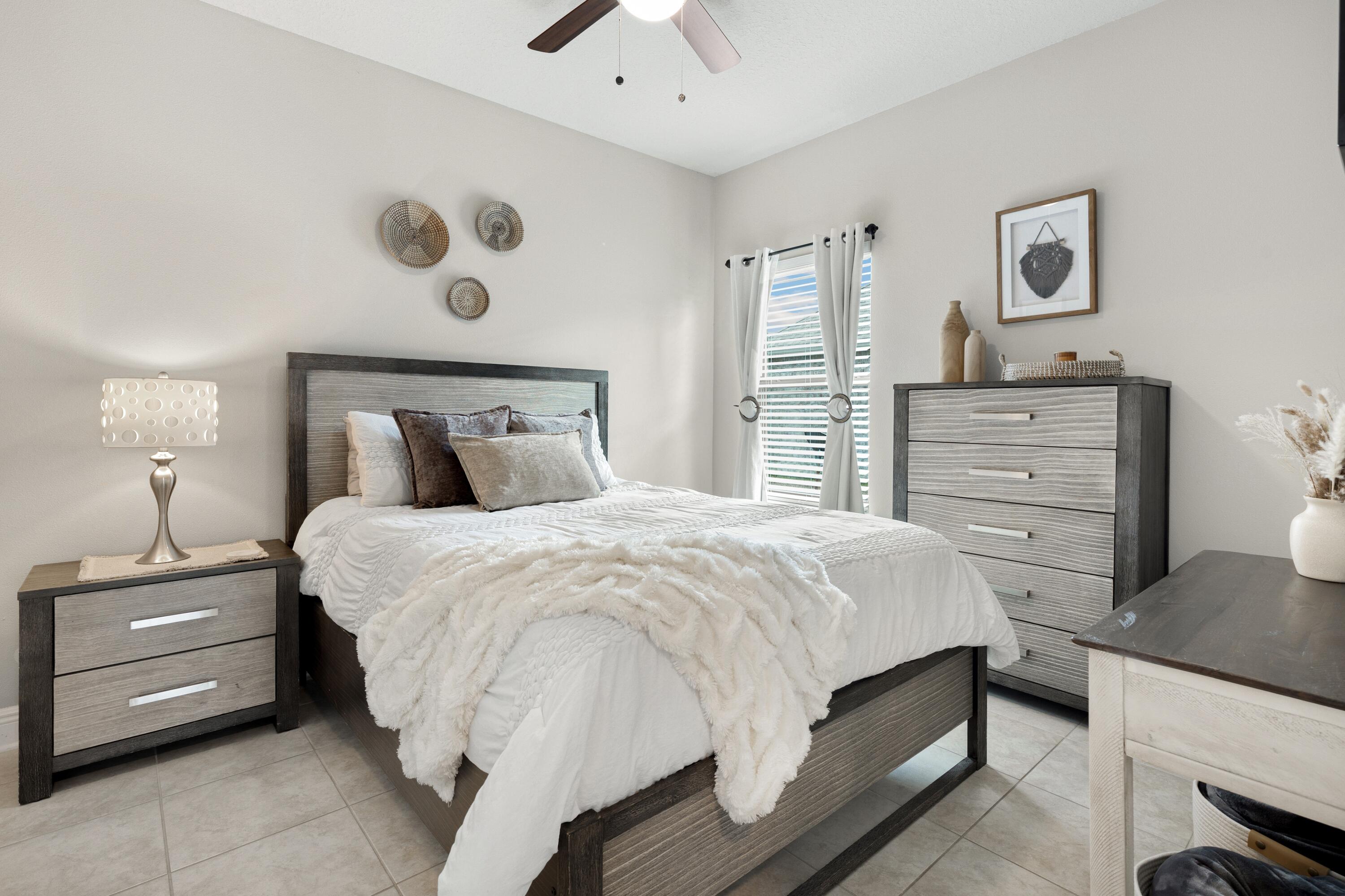 114 Maddox Street Santa Rosa Beach, FL 32459 - Photo 22 of 31 a bedroom with a bed and a chandelier