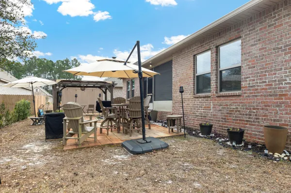 a view of a patio with table and chairs