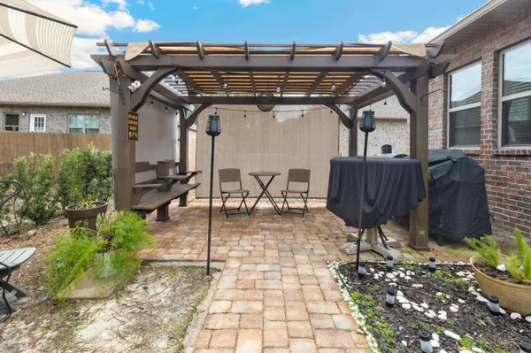 a view of a patio with table and chairs