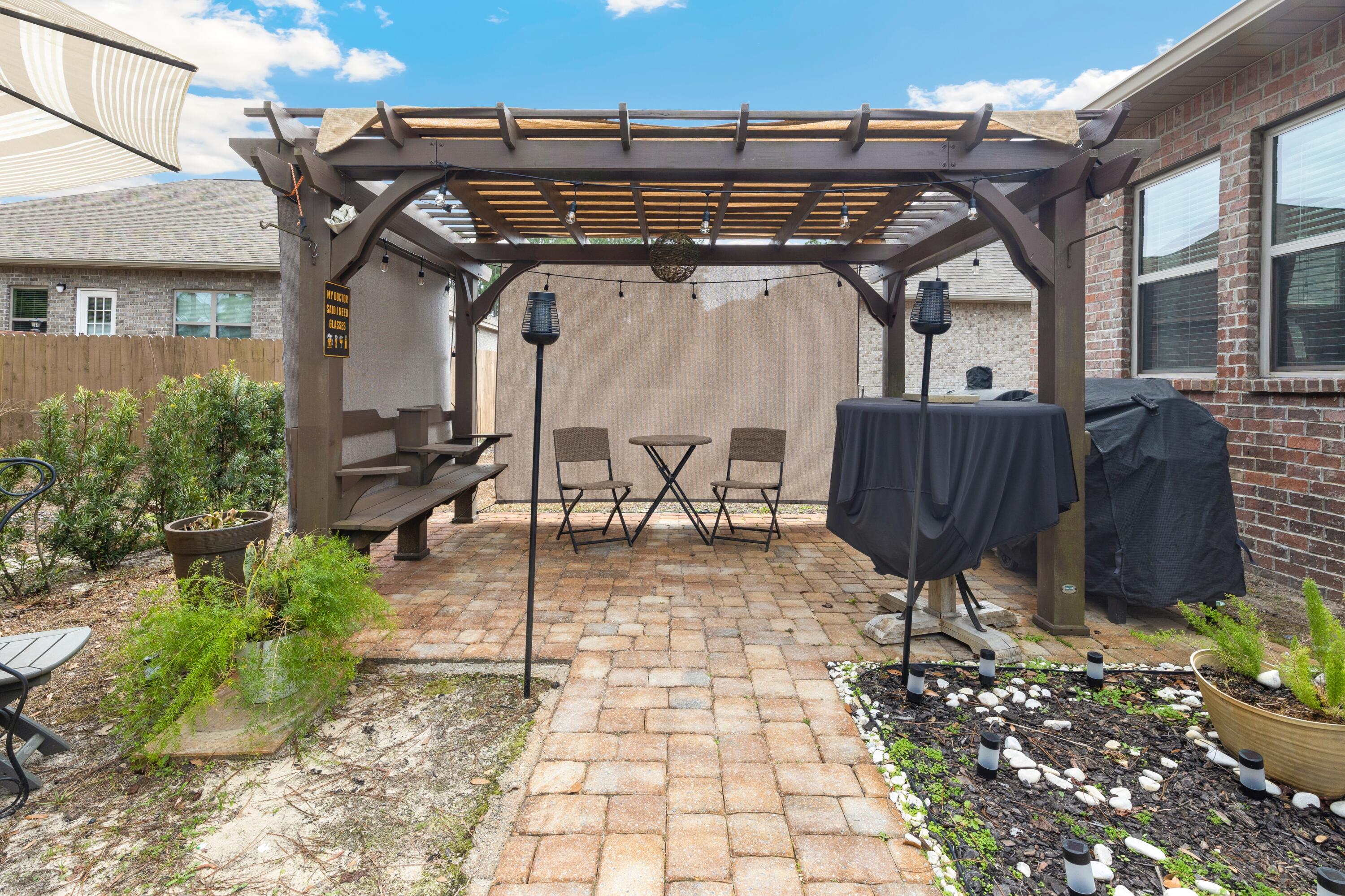 114 Maddox Street Santa Rosa Beach, FL 32459 - Photo 29 of 31 a view of a patio with table and chairs