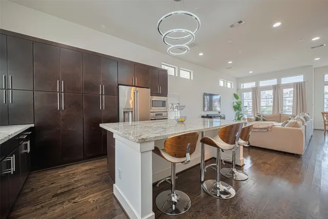 a kitchen with a table chairs and a wooden floor
