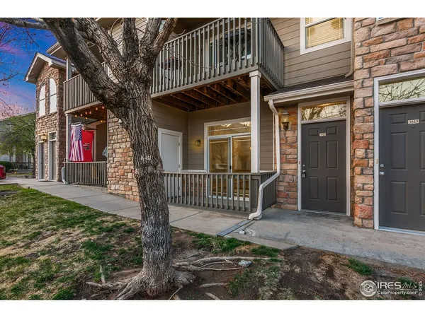 a view of a house with a small yard and wooden fence