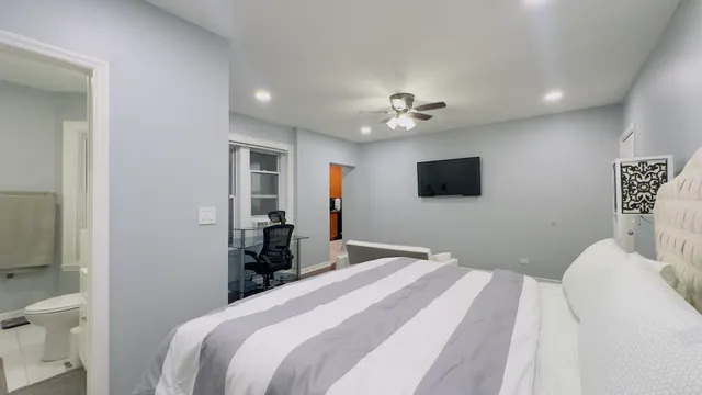 a bedroom with a bed and a flat screen tv