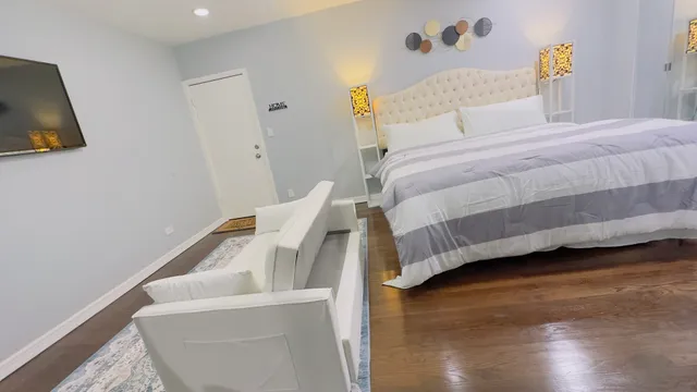a bedroom with a bed and a flat screen tv