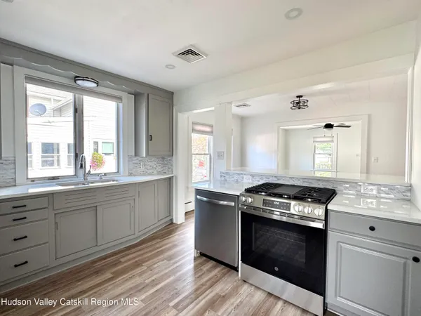 a kitchen with granite countertop a stove and a sink