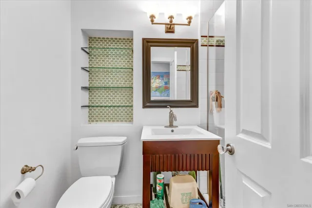 a bathroom with a toilet a sink and a window