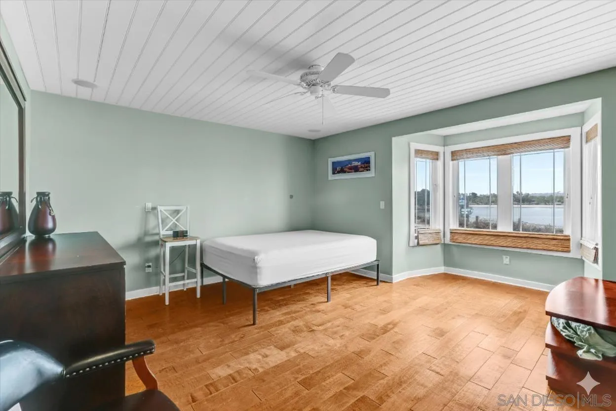 3335 Riviera Drive San Diego, CA 92109 - Photo 10 of 22 a bedroom with furniture and a large window